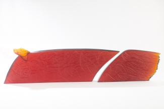 Two pieced, long, rectangular glass sculpture. Colour is burnt orange.
