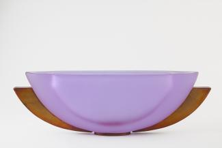Glass sculpture of two layered half circles, one lavender, the other bronze in colour. 